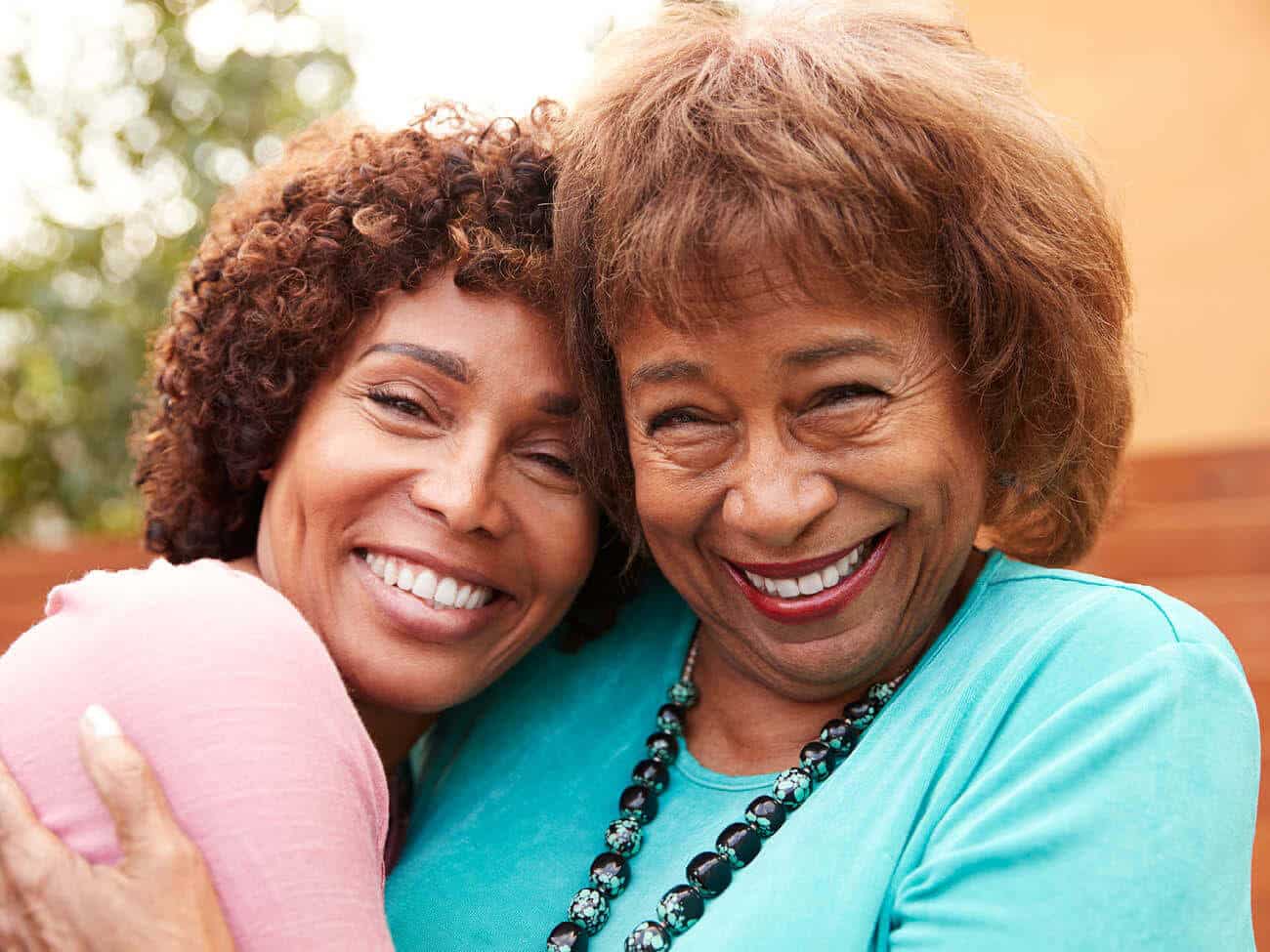 mother and daughter hugging and smiling