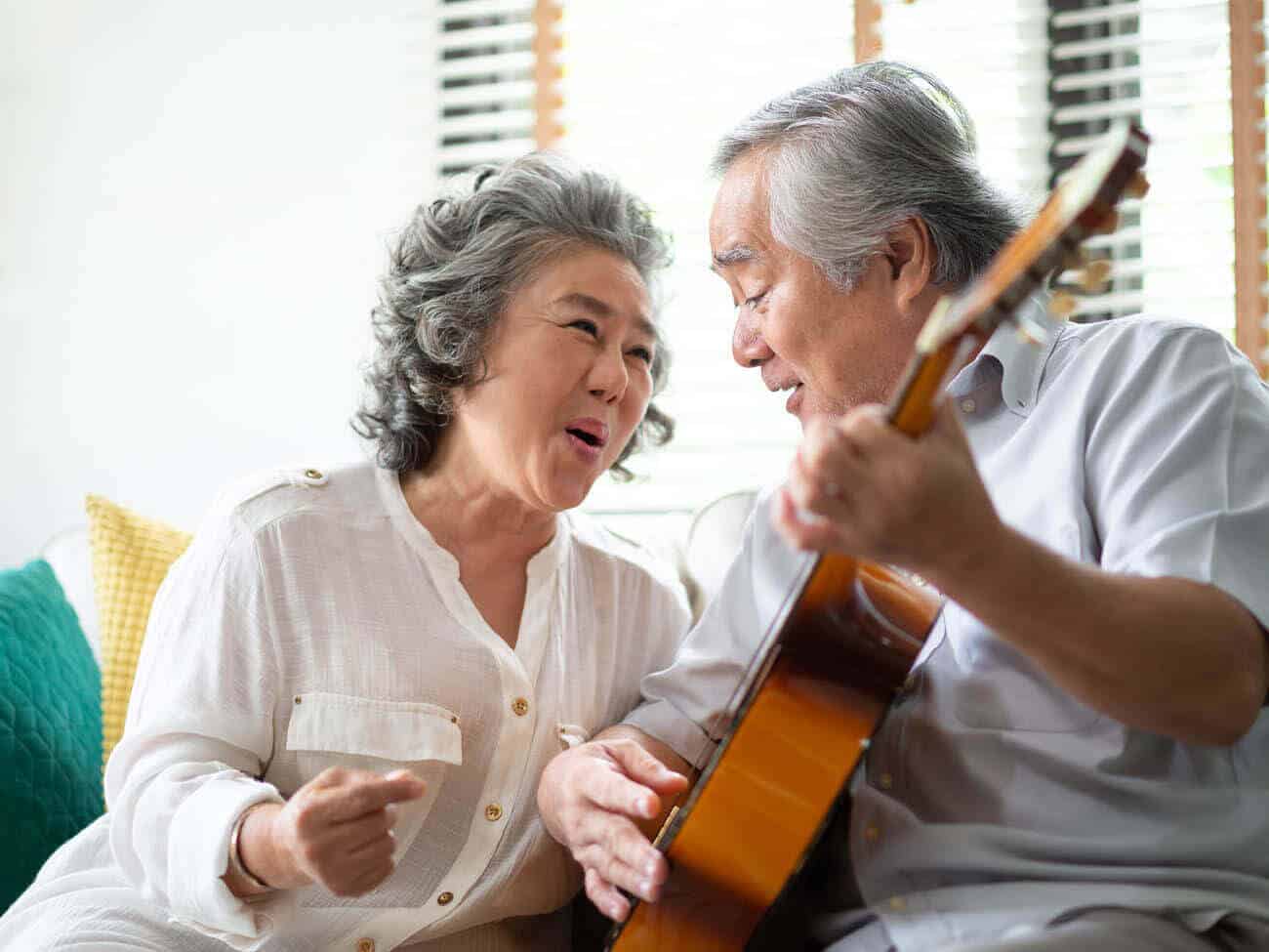 senior couple singing and playing guitar 2
