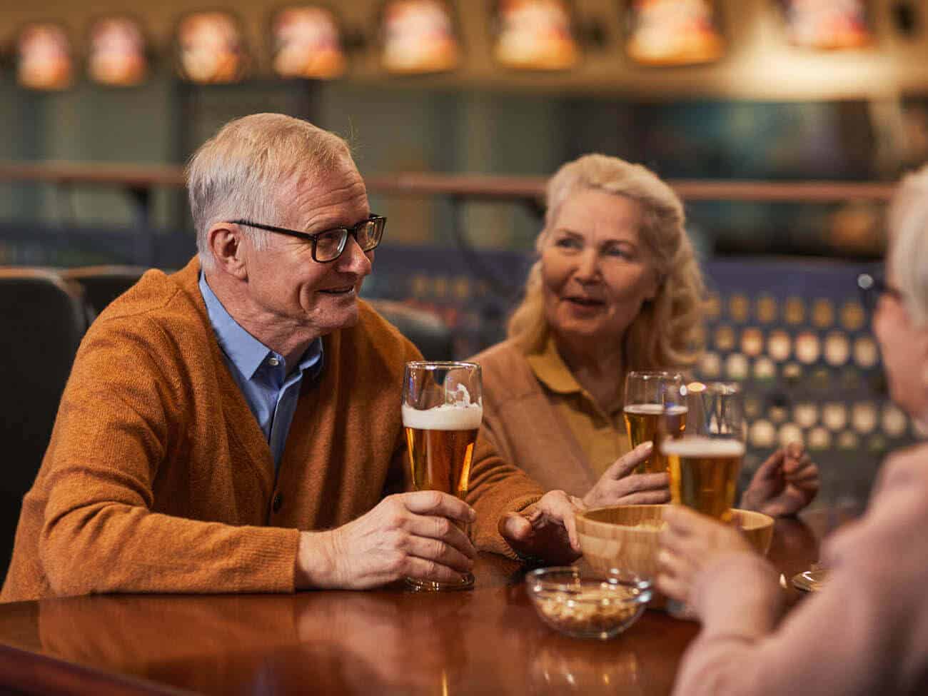 senior couples talking and having a beer