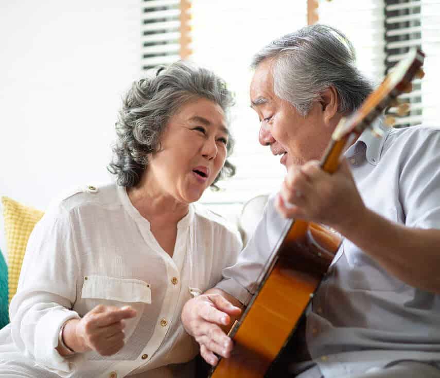 couple singing and playing guitar