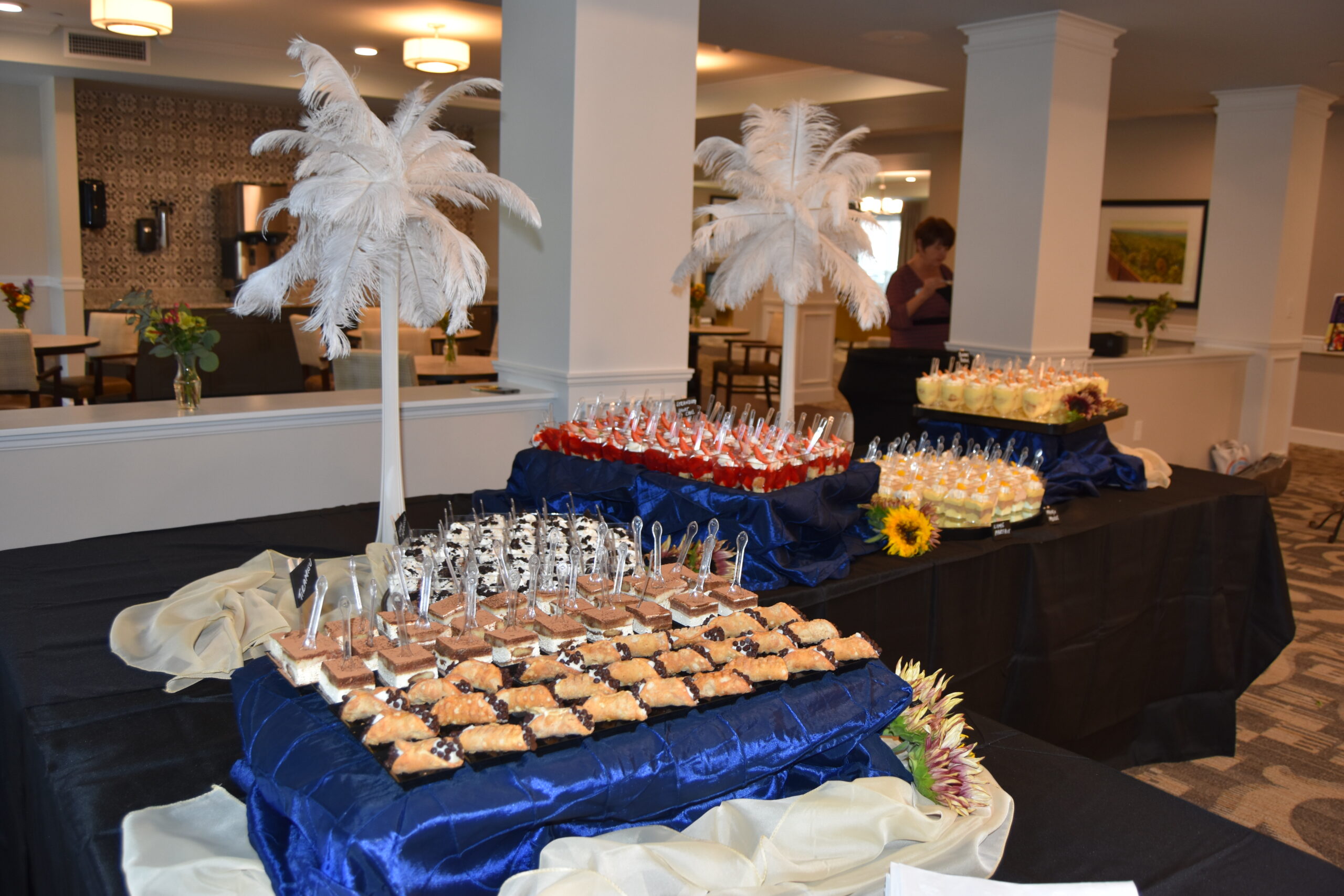 desserts cups with spoons displayed on blue cloths
