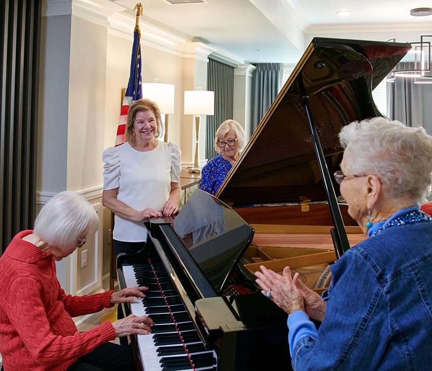 group of women enjoying a piano