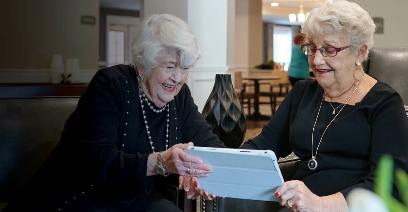 two women visiting loved ones on a tablet
